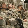 Tired U.S. soldiers leaning up against wall